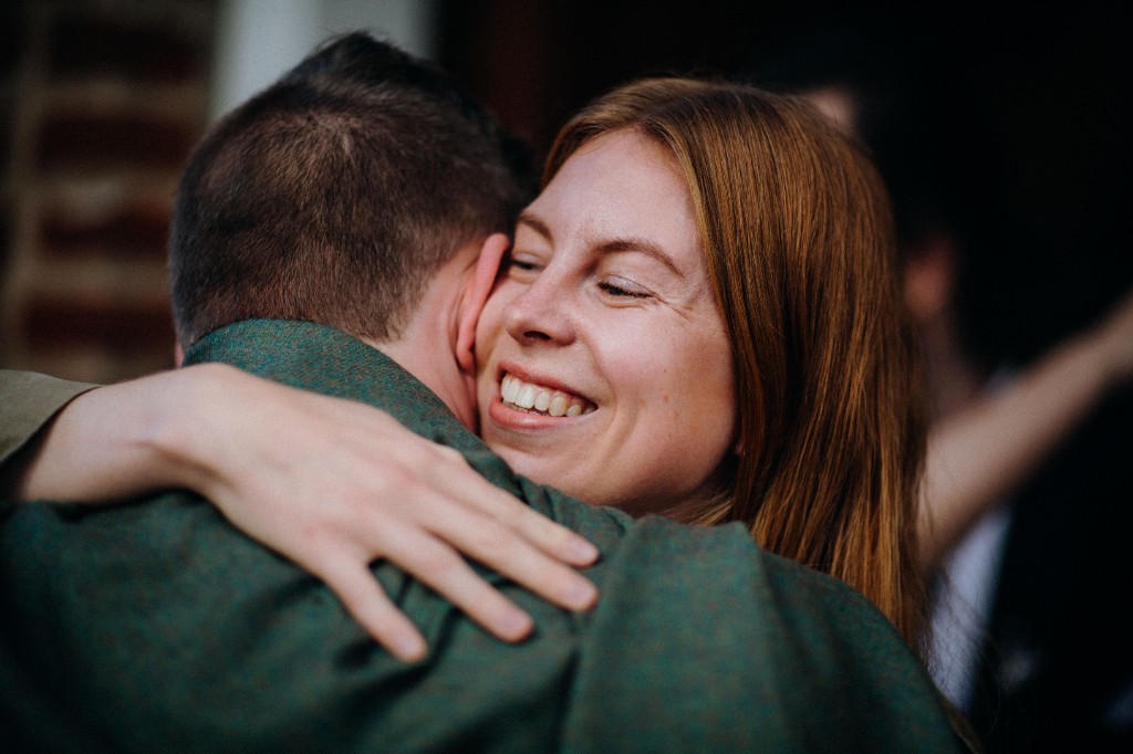 Two people hugging at a reunion celebration